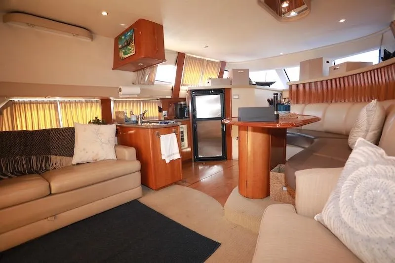 Slide: The Image of Luxurious interior of 2006 Carver 42 Super Sport yacht with modern kitchen and seating area. - 31