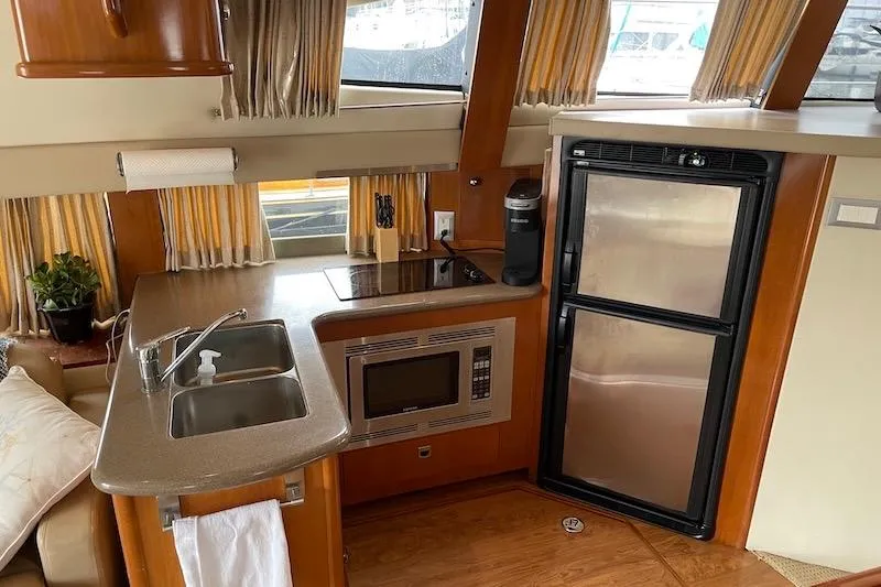Slide: The Image of Interior of 2006 Carver 42 Super Sport yacht kitchen with appliances and sink. - 40