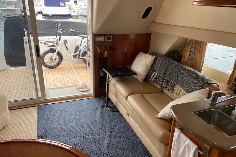 Slide: The Image of Interior of 2006 Carver 42 Super Sport yacht with cozy seating and outdoor view. - 41