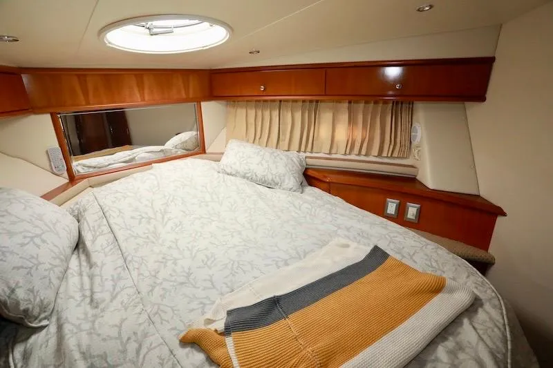Slide: The Image of Luxurious cabin interior of 2006 Carver 42 Super Sport yacht with cozy bedding. - 47