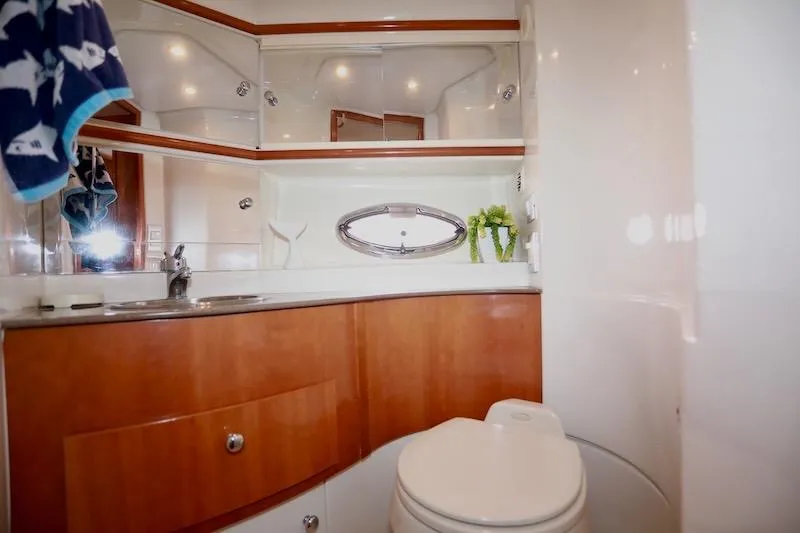 Slide: The Image of Luxurious bathroom in 2006 Carver 42 Super Sport yacht with wood cabinetry and modern fixtures. - 48