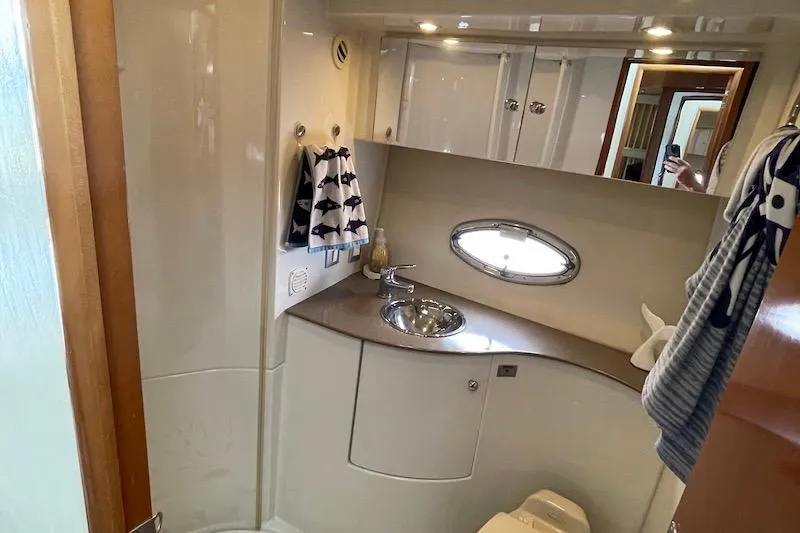 Slide: The Image of Bathroom interior of 2006 Carver 42 Super Sport yacht with sink and porthole window. - 54