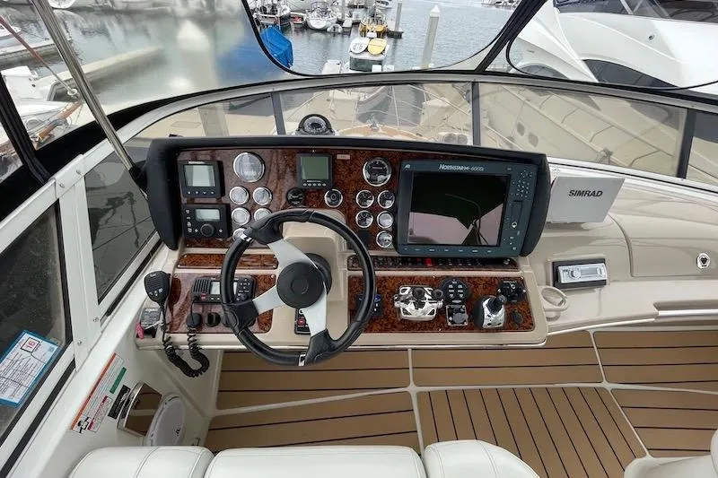 Slide: The Image of Helm of 2006 Carver 42 Super Sport yacht with navigation instruments and steering wheel. - 18