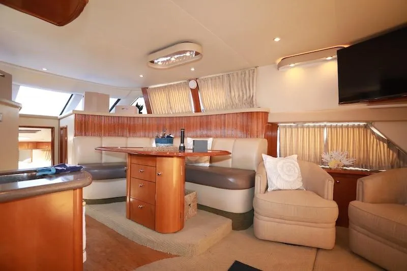 Slide: The Image of Luxurious interior of 2006 Carver 42 Super Sport yacht with elegant seating and dining area. - 29
