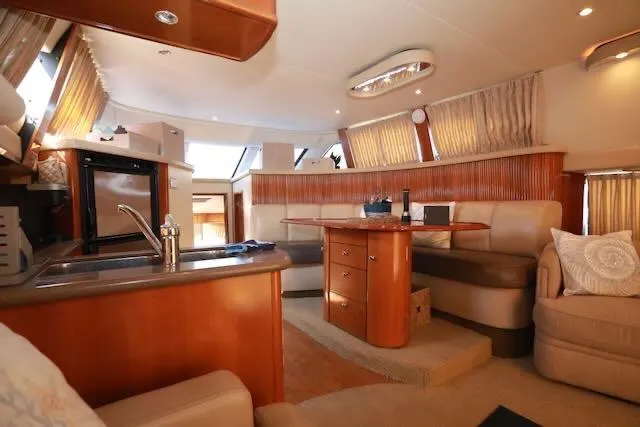 Slide: The Image of Luxurious interior of 2006 Carver 42 Super Sport yacht with elegant seating and kitchenette. - 33