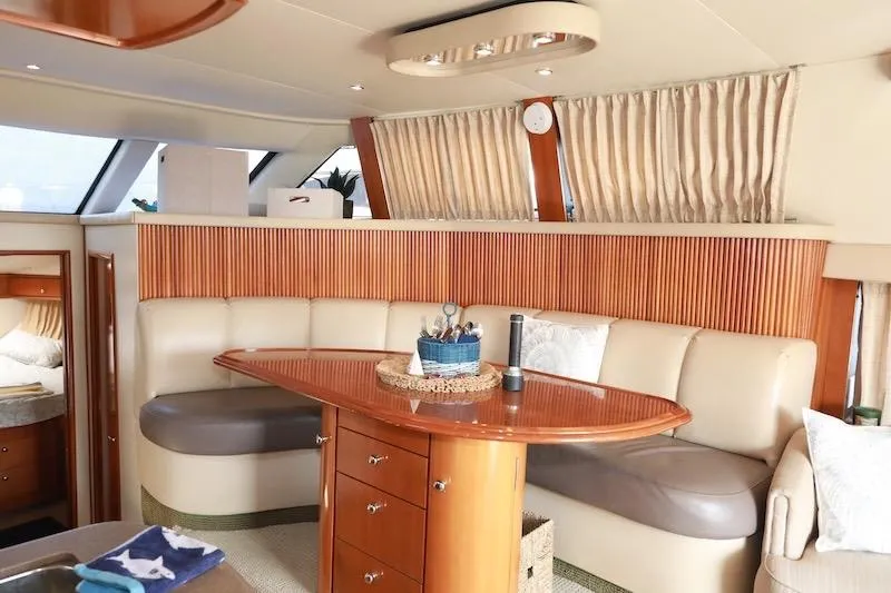 Slide: The Image of Luxurious interior of 2006 Carver 42 Super Sport yacht with elegant seating and wooden accents. - 36