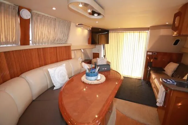 Slide: The Image of Interior of 2006 Carver 42 Super Sport yacht with elegant seating and wooden accents. - 37