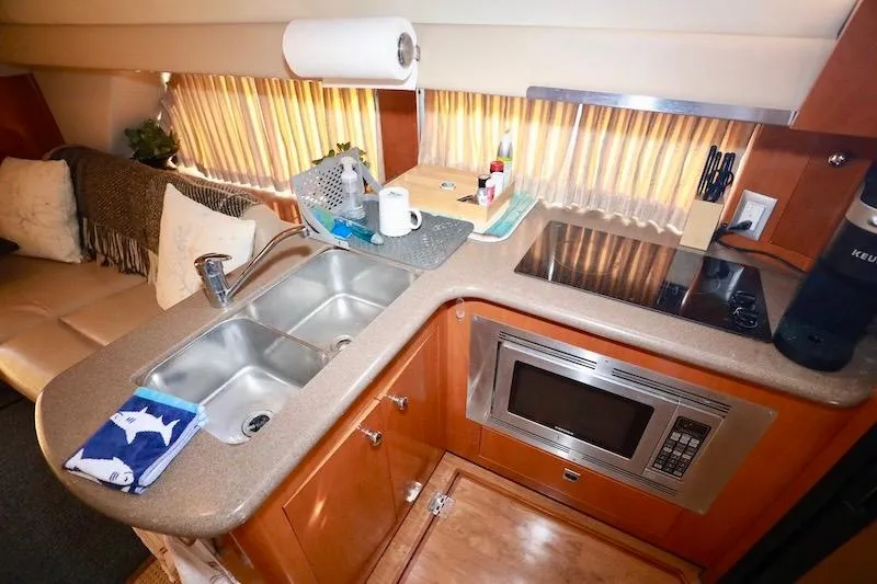 Slide: The Image of 2006 Carver 42 Super Sport yacht kitchen with sink, microwave, and stovetop. - 39
