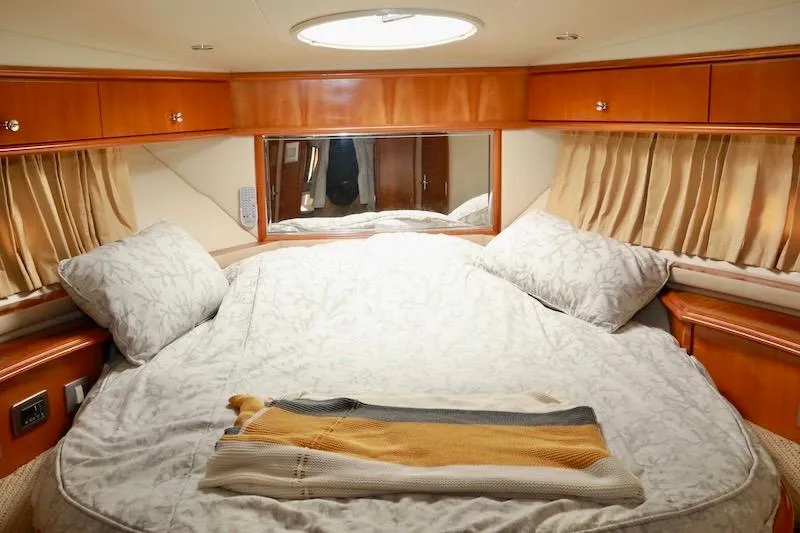 Slide: The Image of Luxurious bedroom interior of 2006 Carver 42 Super Sport yacht with elegant bedding. - 46