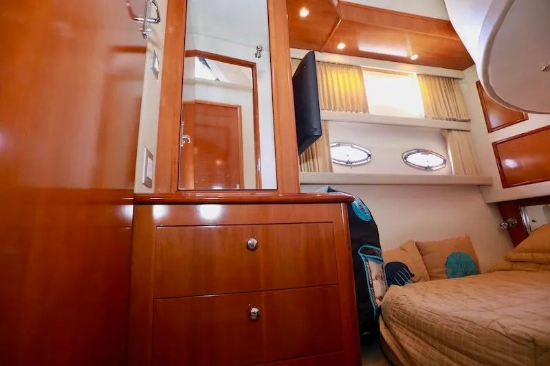 Slide: The Image of Interior of 2006 Carver 42 Super Sport yacht with wood cabinetry and cozy bedding. - 51