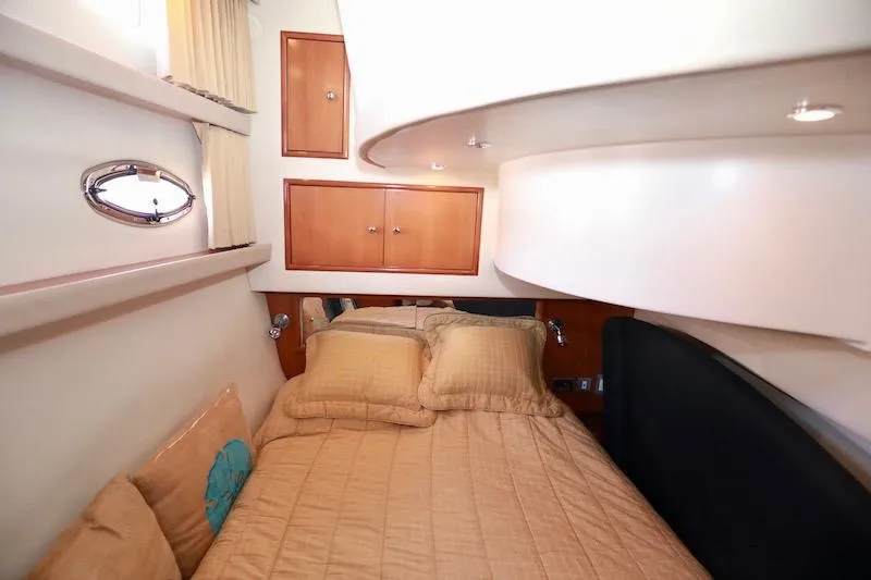 Slide: The Image of Interior cabin of 2006 Carver 42 Super Sport yacht with cozy bedding and wooden cabinets. - 52