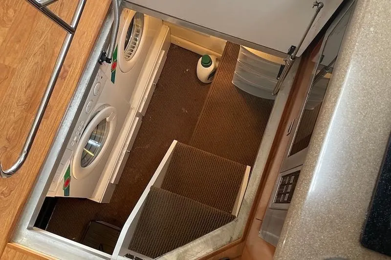 Slide: The Image of Laundry area in 2006 Carver 42 Super Sport yacht with washer and dryer. - 56