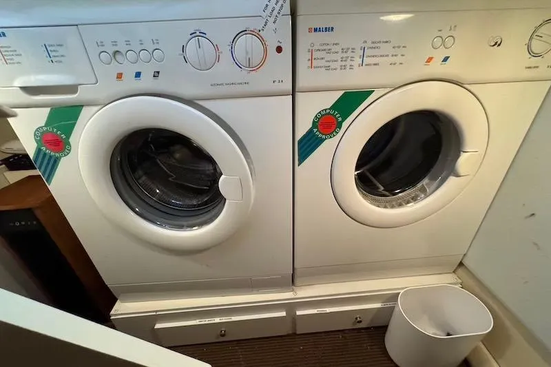 Slide: The Image of Laundry area with two front-loading washing machines on a Carver 42 Super Sport yacht. - 57