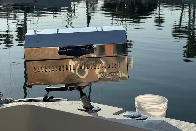 Slide: The Image of Stainless steel grill on 2006 Carver 42 Super Sport boat, docked by calm water. - 58