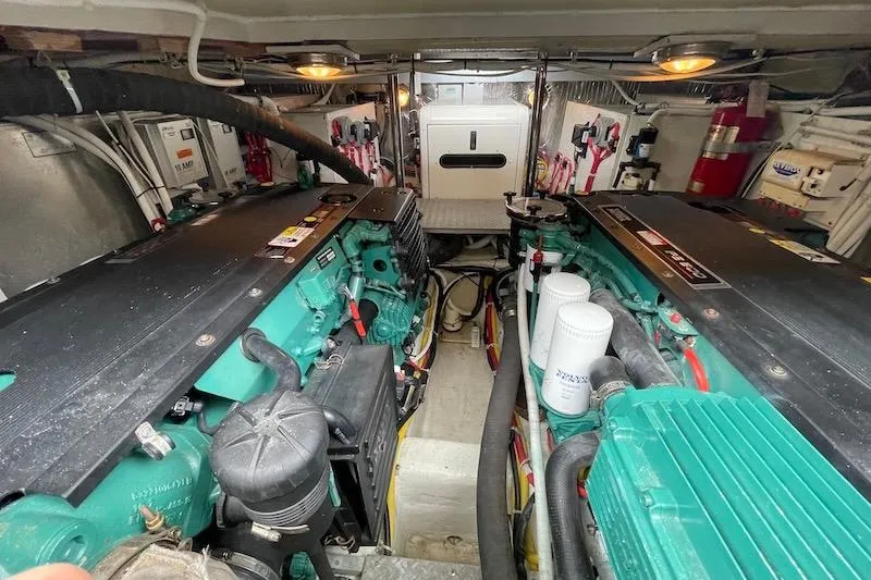 Slide: The Image of Engine room of a 2006 Carver 42 Super Sport yacht, showcasing dual engines and equipment. - 61