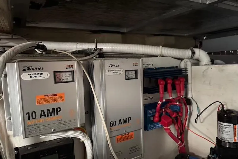 Slide: The Image of Electrical system of a 2006 Carver 42 Super Sport boat, featuring battery chargers and wiring. - 63