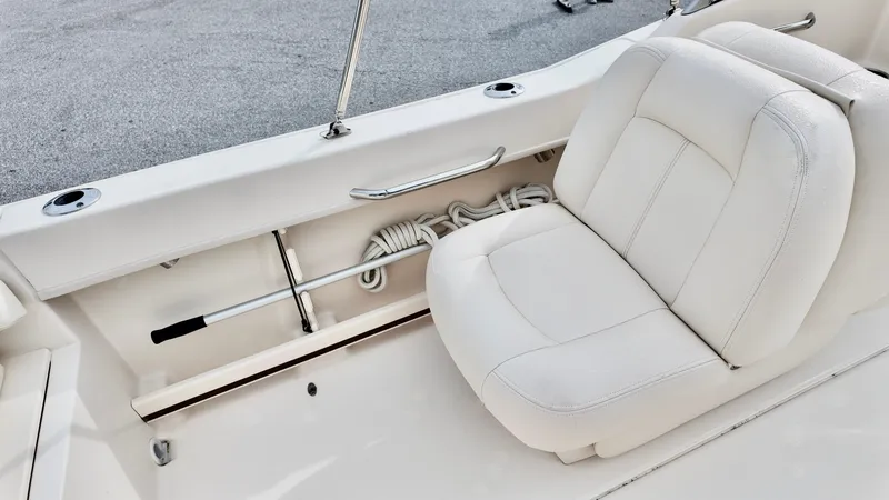 Slide: The Image of 2018 Grady-White Freedom 215 boat interior with white seating and storage compartment. - 11