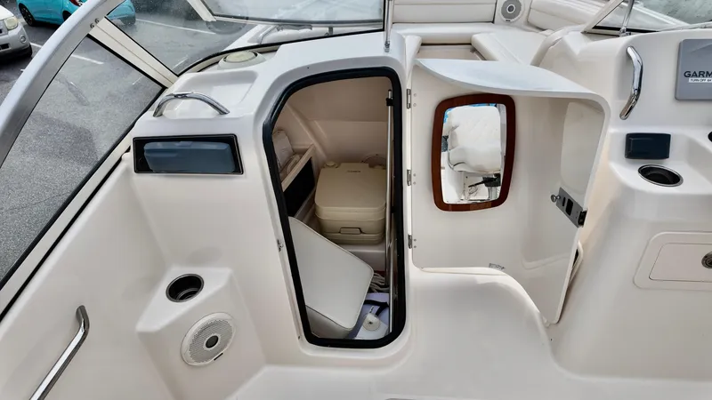 Slide: The Image of 2018 Grady-White Freedom 215 boat interior with open storage compartment and seating area. - 14