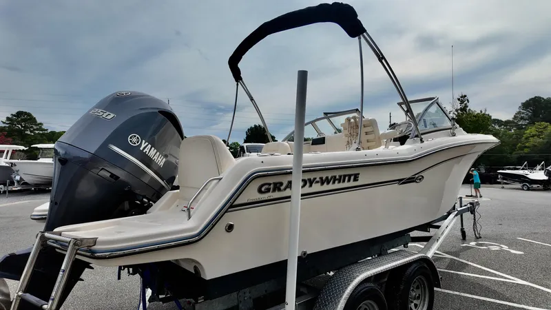 Slide: The Image of 2018 Grady-White Freedom 215 boat on trailer with Yamaha engine in parking lot. - 4