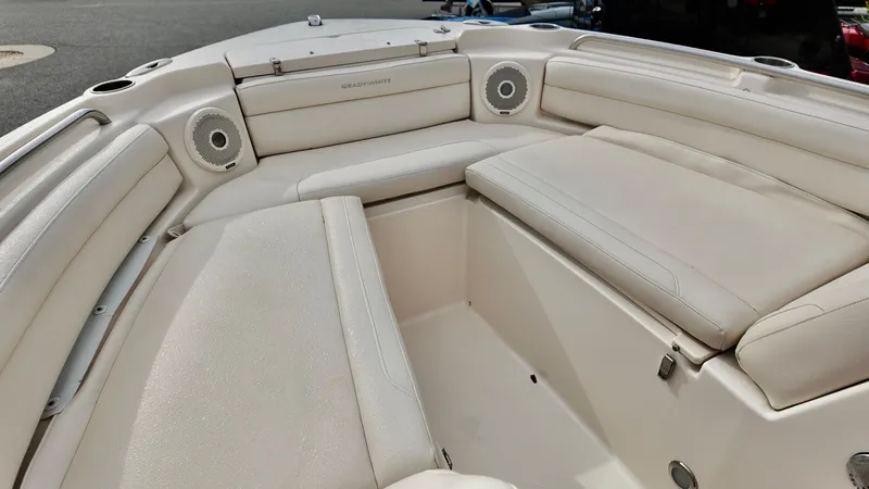 Slide: The Image of 2018 Grady-White Freedom 215 boat interior with cushioned seating and speakers. - 7