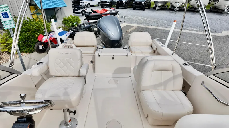 Slide: The Image of 2018 Grady-White Freedom 215 boat interior with seating and steering wheel. - 8