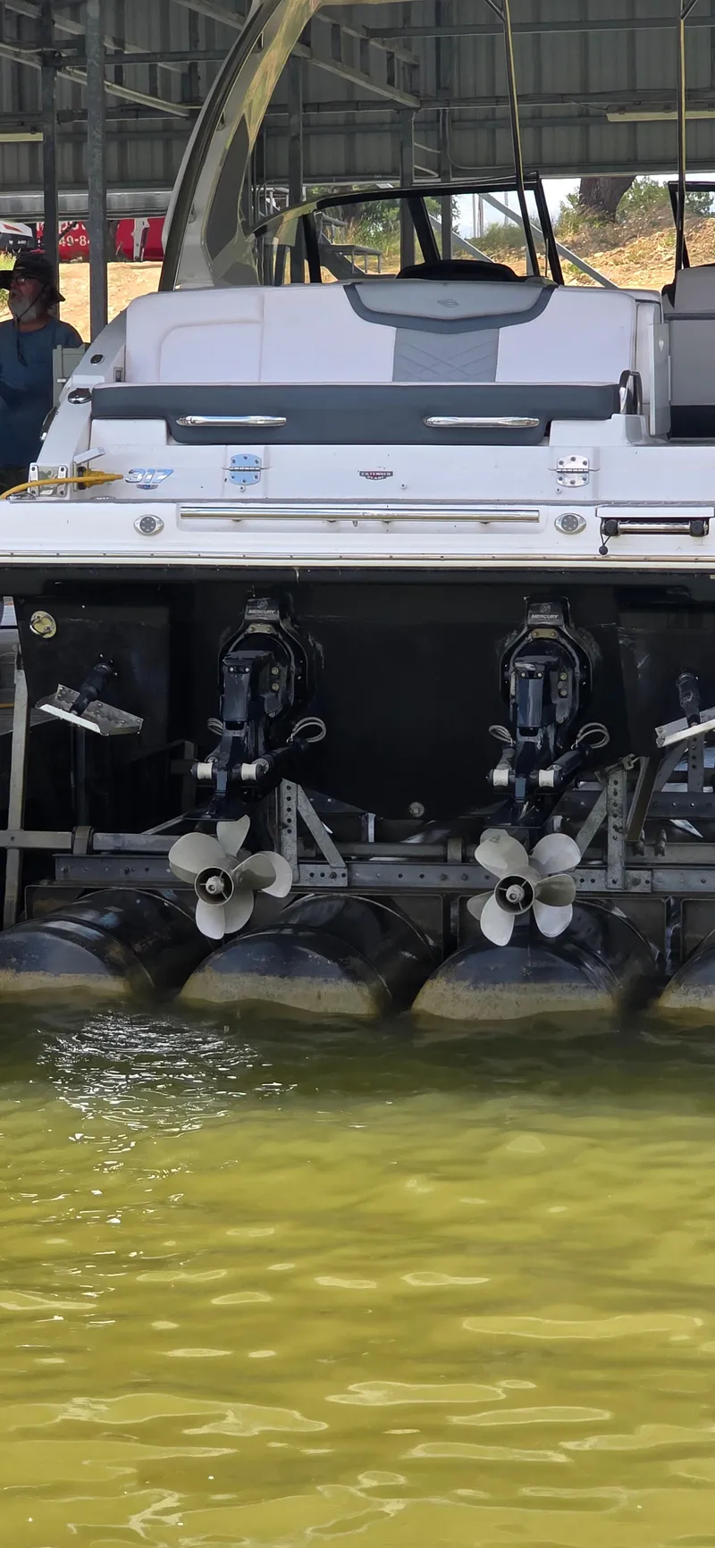 Slide: The Image of 2020 Chaparral 317 SSX boat stern with dual propellers in a marina. - 14