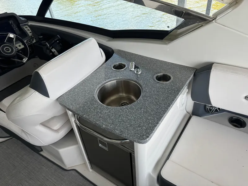 Slide: The Image of 2020 Chaparral 317 SSX boat interior with sink and seating area. - 18