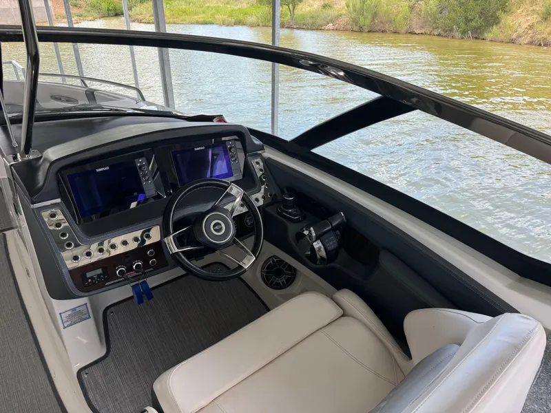 Slide: The Image of 2020 Chaparral 317 SSX boat cockpit with modern controls and dual displays. - 21