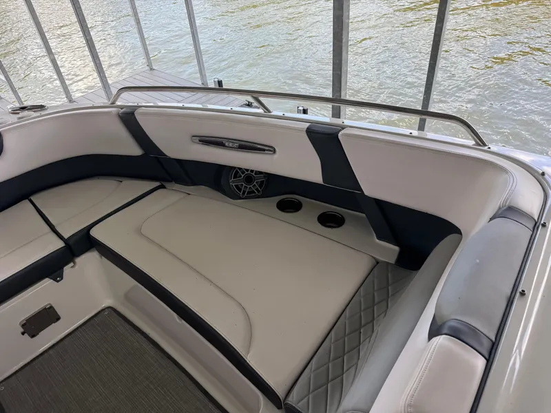 Slide: The Image of 2020 Chaparral 317 SSX boat interior with cushioned seating and speaker. - 25