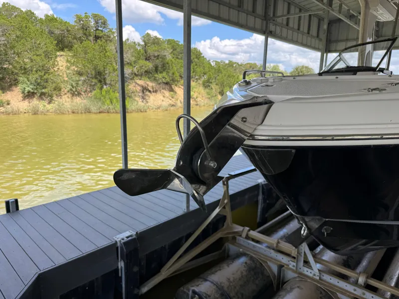 Slide: The Image of Chaparral 317 SSX 2020 boat docked, showing propeller and stern, under covered marina. - 33
