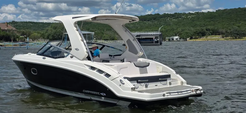 Slide: The Image of 2020 Chaparral 317 SSX boat on a scenic lake with lush green hills. - 4