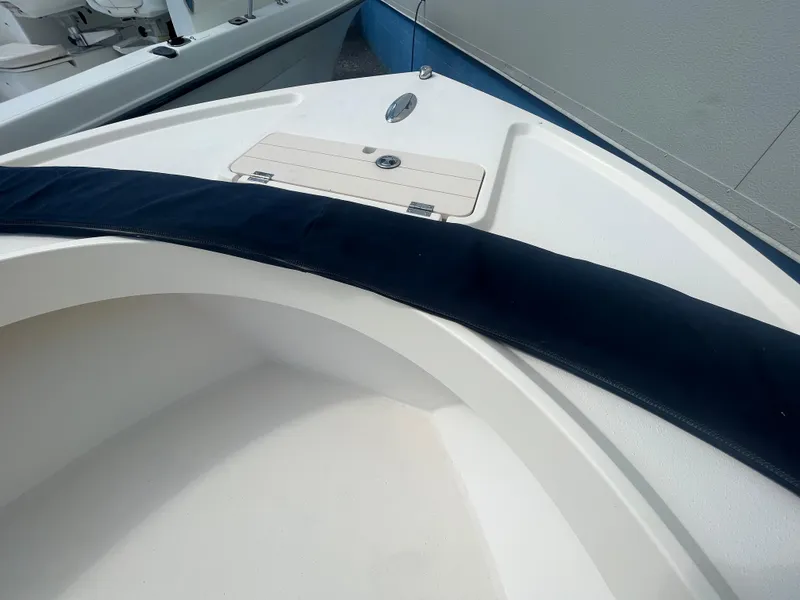 Slide: The Image of 2011 Parker 21SE Center Console boat interior with storage compartment and cushioned seating. - 12