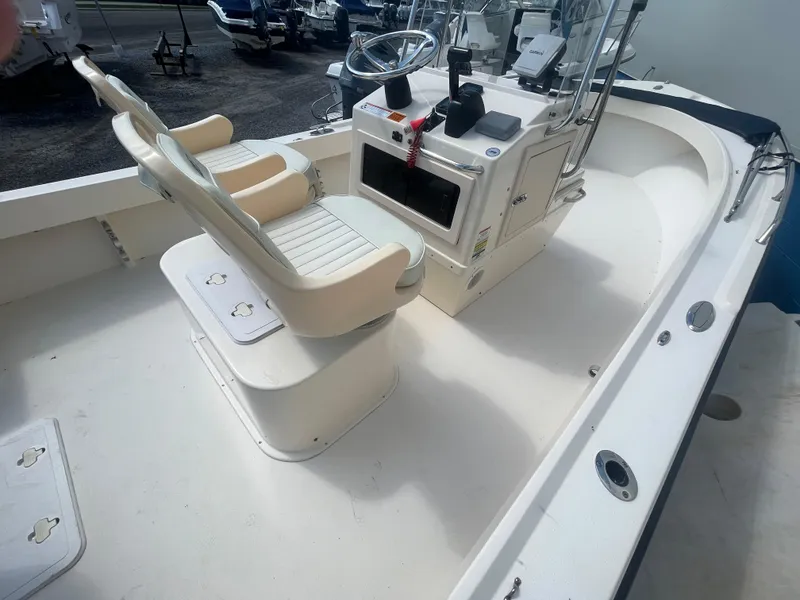 Slide: The Image of 2011 Parker 21SE Center Console boat interior with dual seats and steering console. - 13