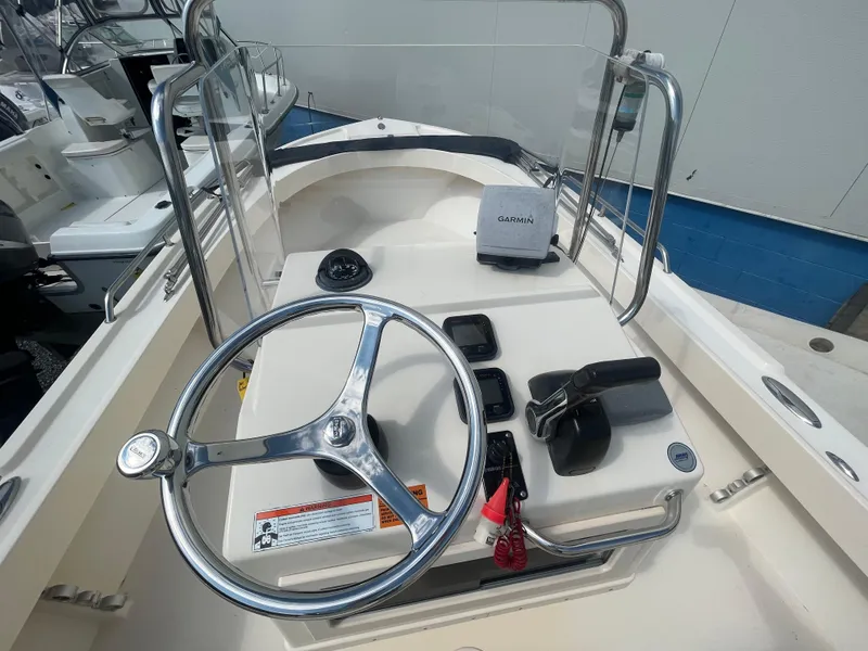 Slide: The Image of 2011 Parker 21SE Center Console boat dashboard with steering wheel and Garmin device. - 14