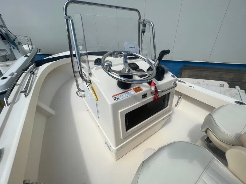 Slide: The Image of 2011 Parker 21SE Center Console boat interior with steering wheel and seating. - 15