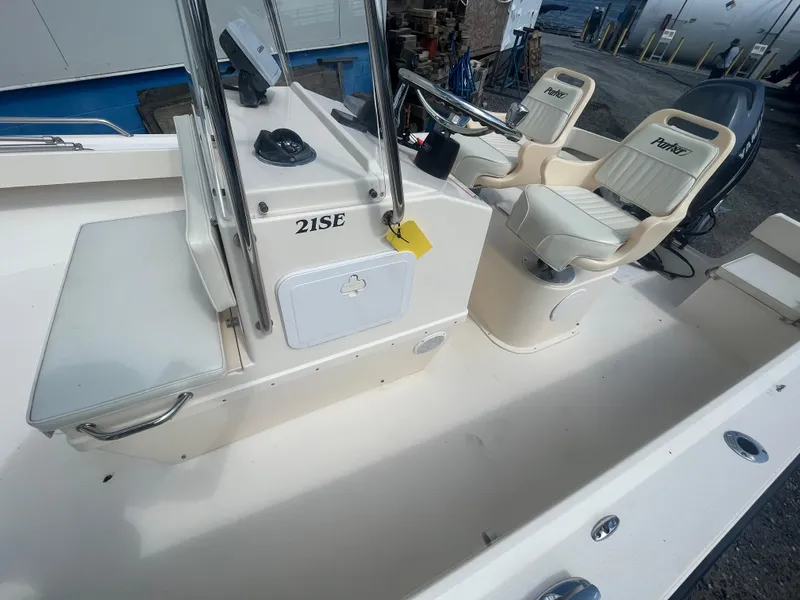 Slide: The Image of 2011 Parker 21SE Center Console boat interior with steering and seating. - 16