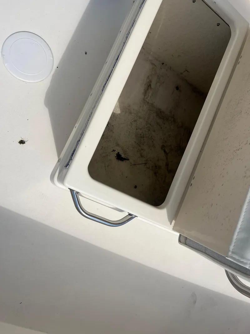 Slide: The Image of Open storage compartment on 2011 Parker 21SE Center Console boat. - 17