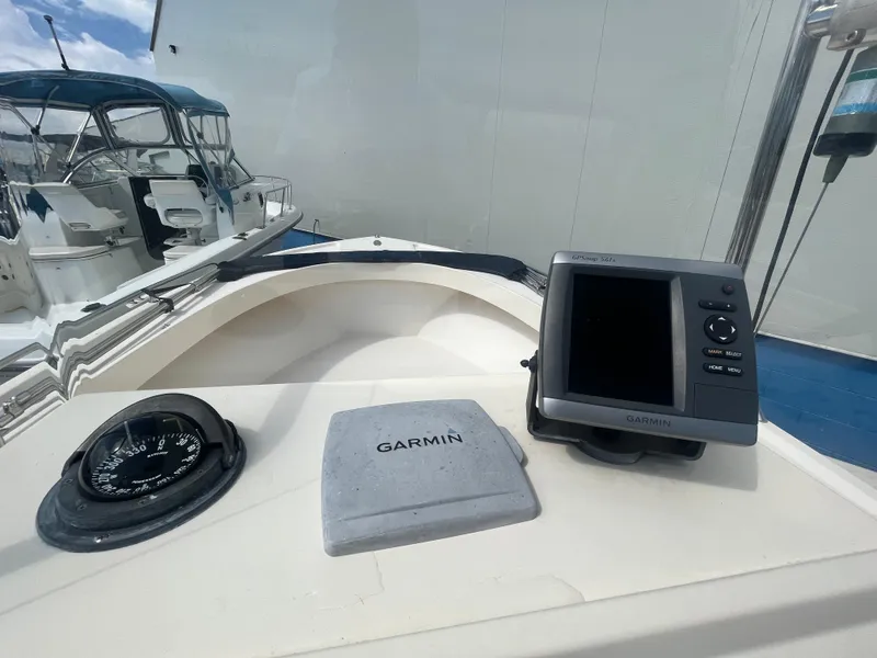 Slide: The Image of 2011 Parker 21SE Center Console with Garmin GPS and compass on dashboard. - 19