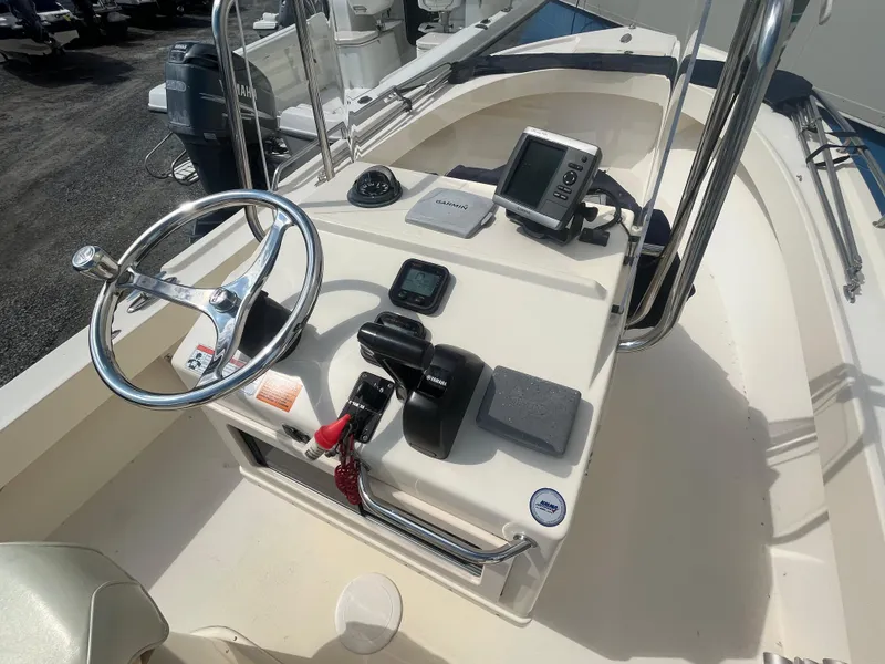 Slide: The Image of 2011 Parker 21SE Center Console boat with steering wheel and navigation equipment. - 22