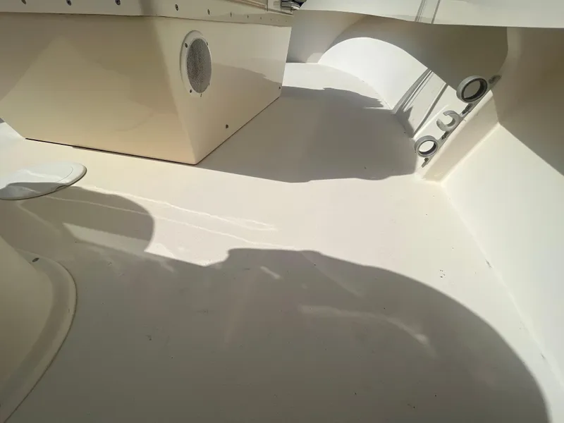 Slide: The Image of Interior view of a 2011 Parker 21SE Center Console boat, showcasing clean deck and storage features. - 23