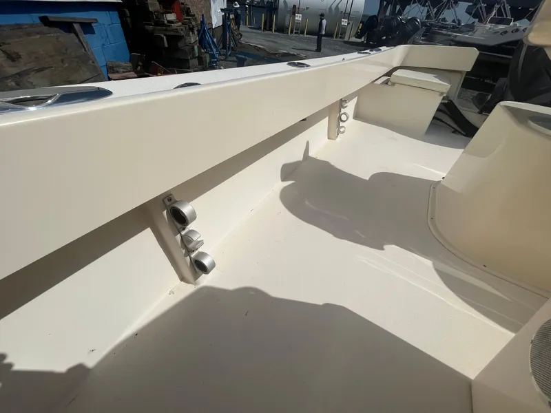 Slide: The Image of 2011 Parker 21SE Center Console boat interior with rod holders and seating. - 24