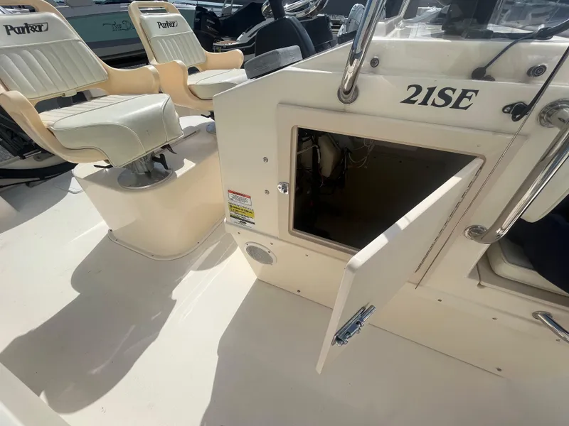 Slide: The Image of 2011 Parker 21SE Center Console boat interior with open storage compartment and seating. - 25