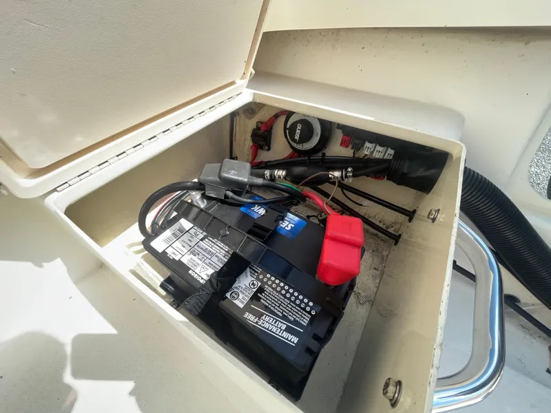 Slide: The Image of Battery compartment of 2011 Parker 21SE Center Console boat, showing wiring and connections. - 26