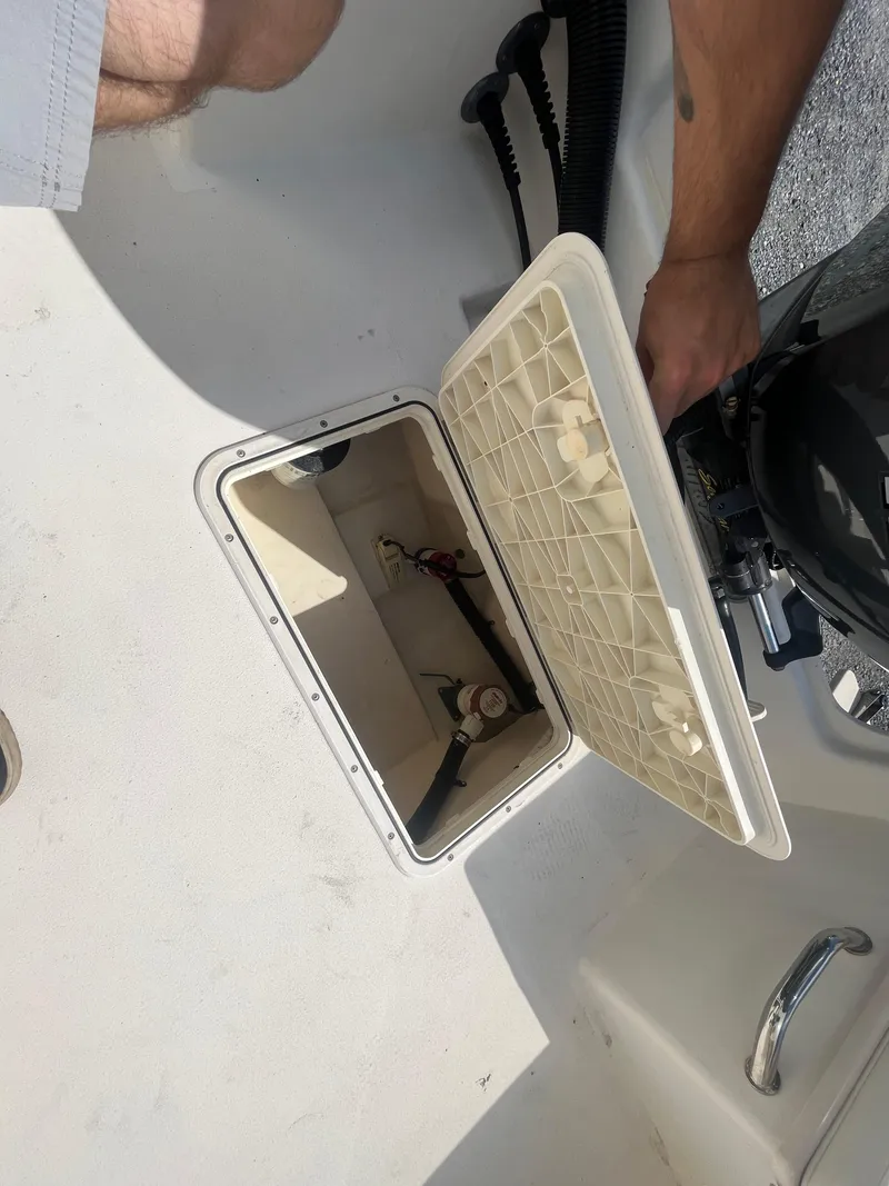 Slide: The Image of Open hatch on 2011 Parker 21SE Center Console boat, showing interior components. - 28