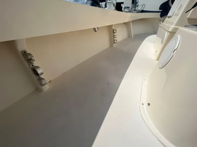 Slide: The Image of 2011 Parker 21SE Center Console boat interior with rod holders and seating. - 29