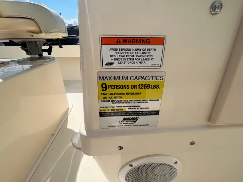 Slide: The Image of 2011 Parker 21SE Center Console capacity warning label, 9 persons or 1269 lbs limit. - 30