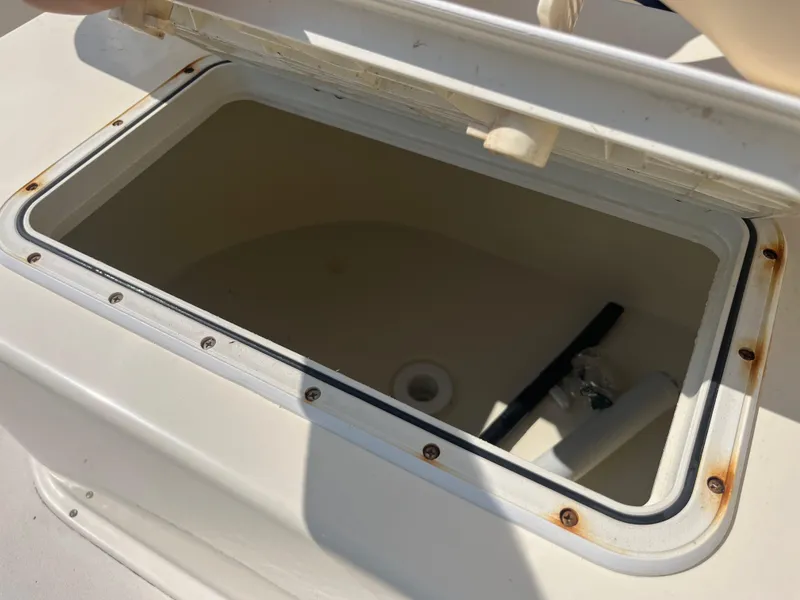 Slide: The Image of Open storage compartment on a 2011 Parker 21SE Center Console boat. - 35