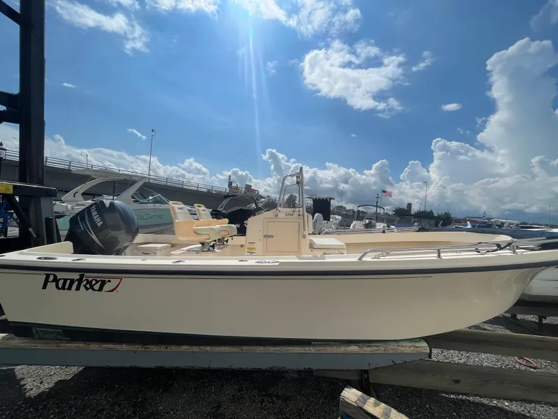 Slide: The Image of 2011 Parker 21SE Center Console boat on display under a bright blue sky. - 5