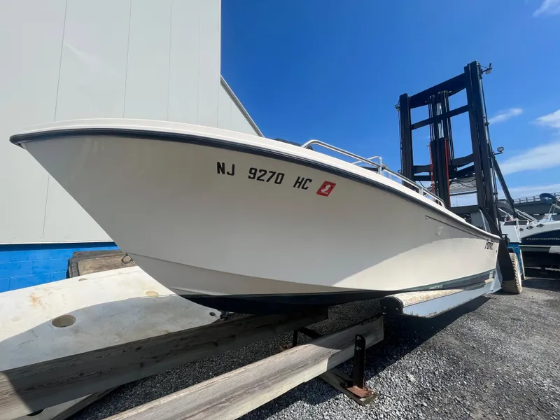 Slide: The Image of 2011 Parker 21SE Center Console boat on a trailer, displayed outdoors. - 7