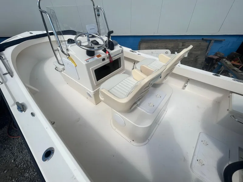 Slide: The Image of 2011 Parker 21SE Center Console boat interior with steering wheel and seating. - 8